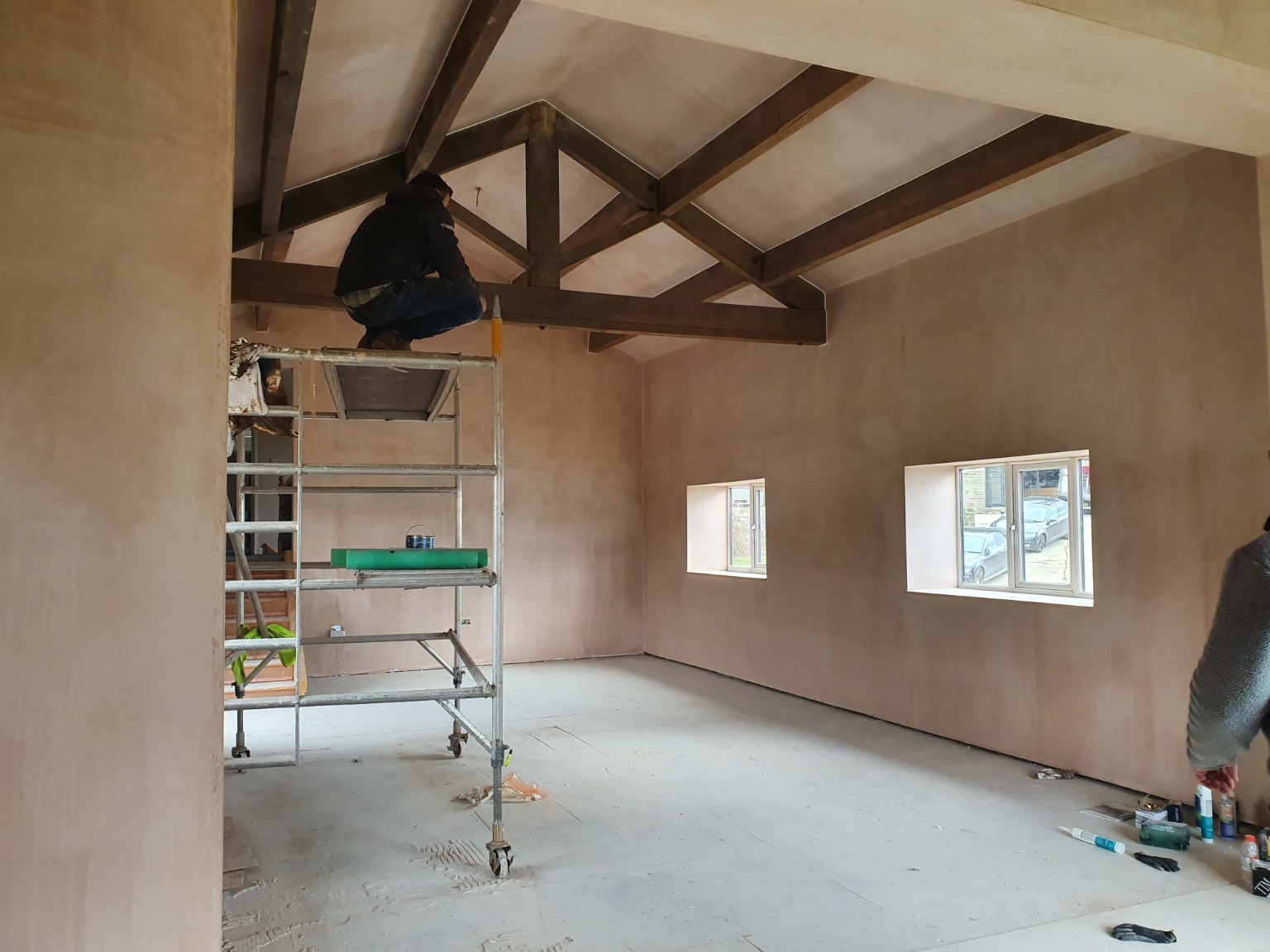 Finished plaster around exposed barn beams